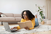 Young black woman reading book near laptop, getting ready for exam or working o, a Photo by Prostock-Studio (Thumbnail 2 of 2)