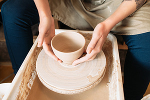 craftswoman taking clay bowl pottery wheel, an Arts & Entertainment Photo by Photo Drive Studio
