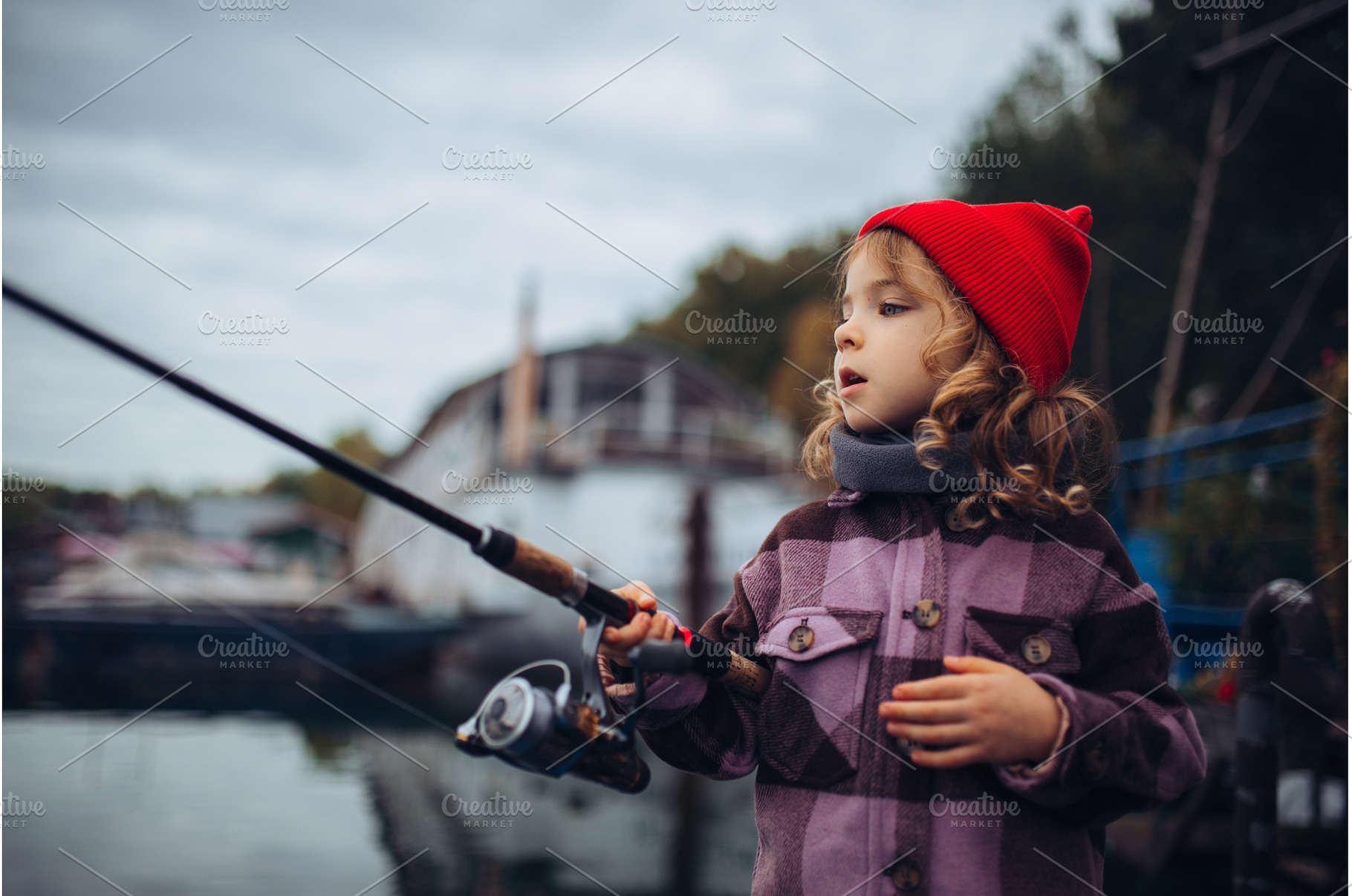 Child enjoying fishing outdoors, a Sports & Recreation Photo by HalfPoint