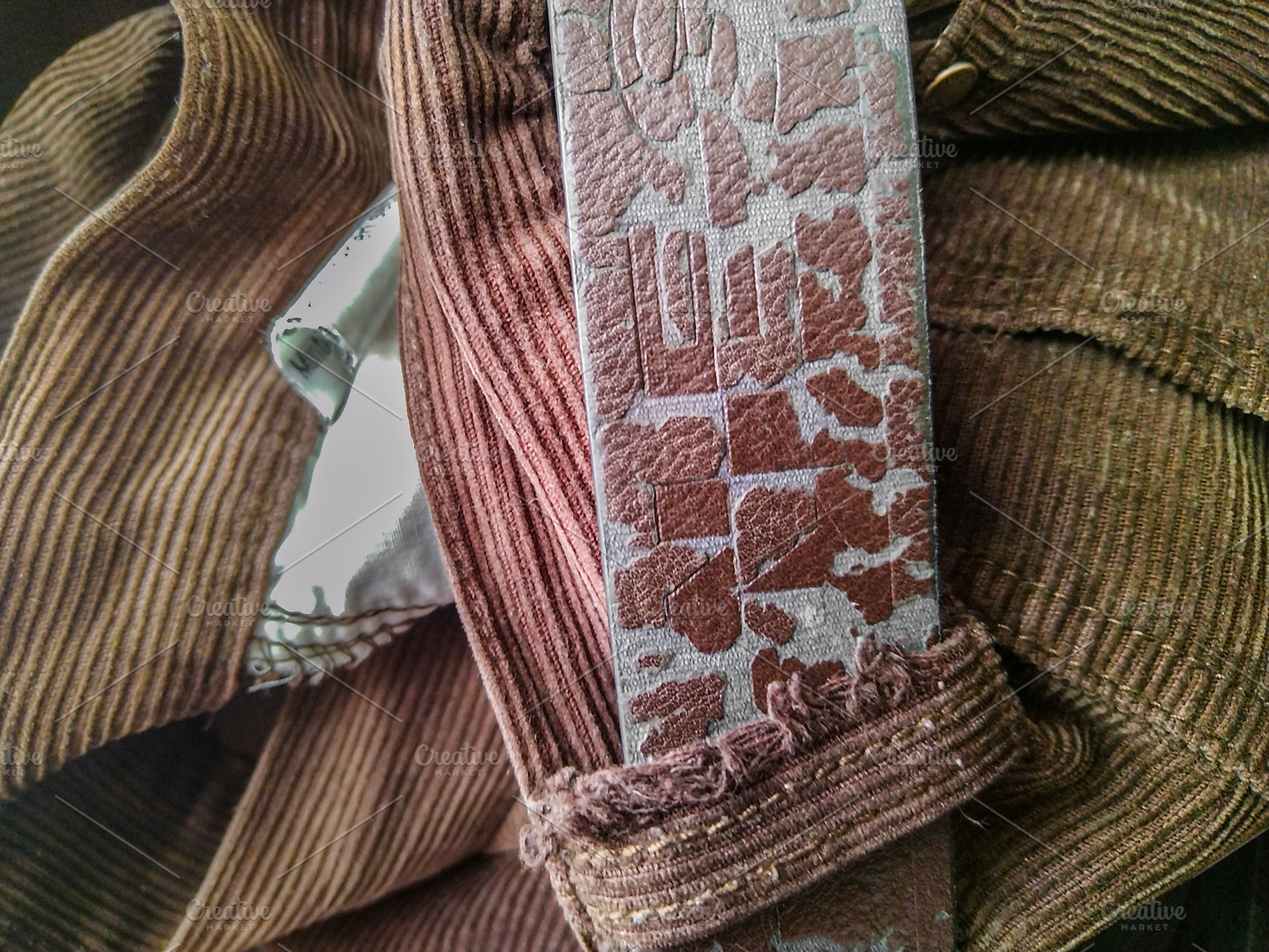 Folded clothes and leather belt from above, an Abstract Photo by DanFLCreativo