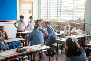Children laughing during classroom activity, a School & Education Photo by etorres69