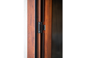 Black metal door hinge attaching a, an Architecture Photo by volodymyrshtun13795