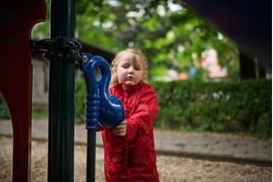 Child in red raincoat spending free, a Nature Photo by HalfPoint