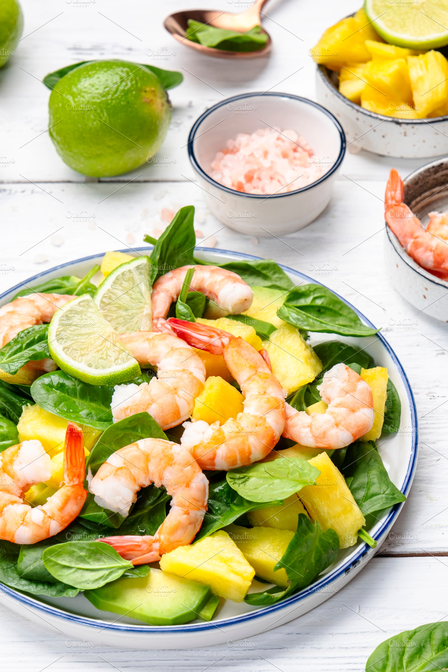Shrimp pineapple salad with spinach, avocado and lime on white w, a Food & Drink Photo by 5PH