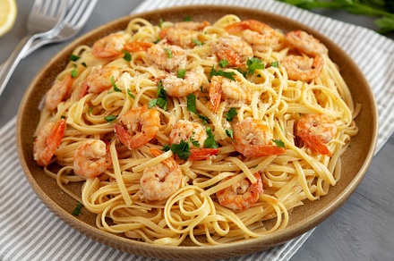 Baked Shrimp Scampi Linguine Pasta with Parsley on a Plate, side, a Food & Drink Photo by LiudmylaChuhunova