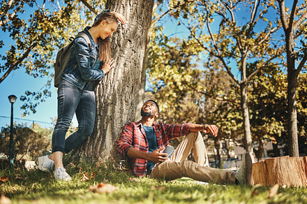 Relax, together and interracial couple on a park date for love, anniversary and happiness in Italy. Smile, conversation and black man and woman speaking while in nature for peace, relaxing and care, a Photo by Peopleimages.com