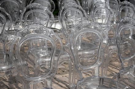 Transparent chairs stand in rows, an Abstract Photo by Schreibikus