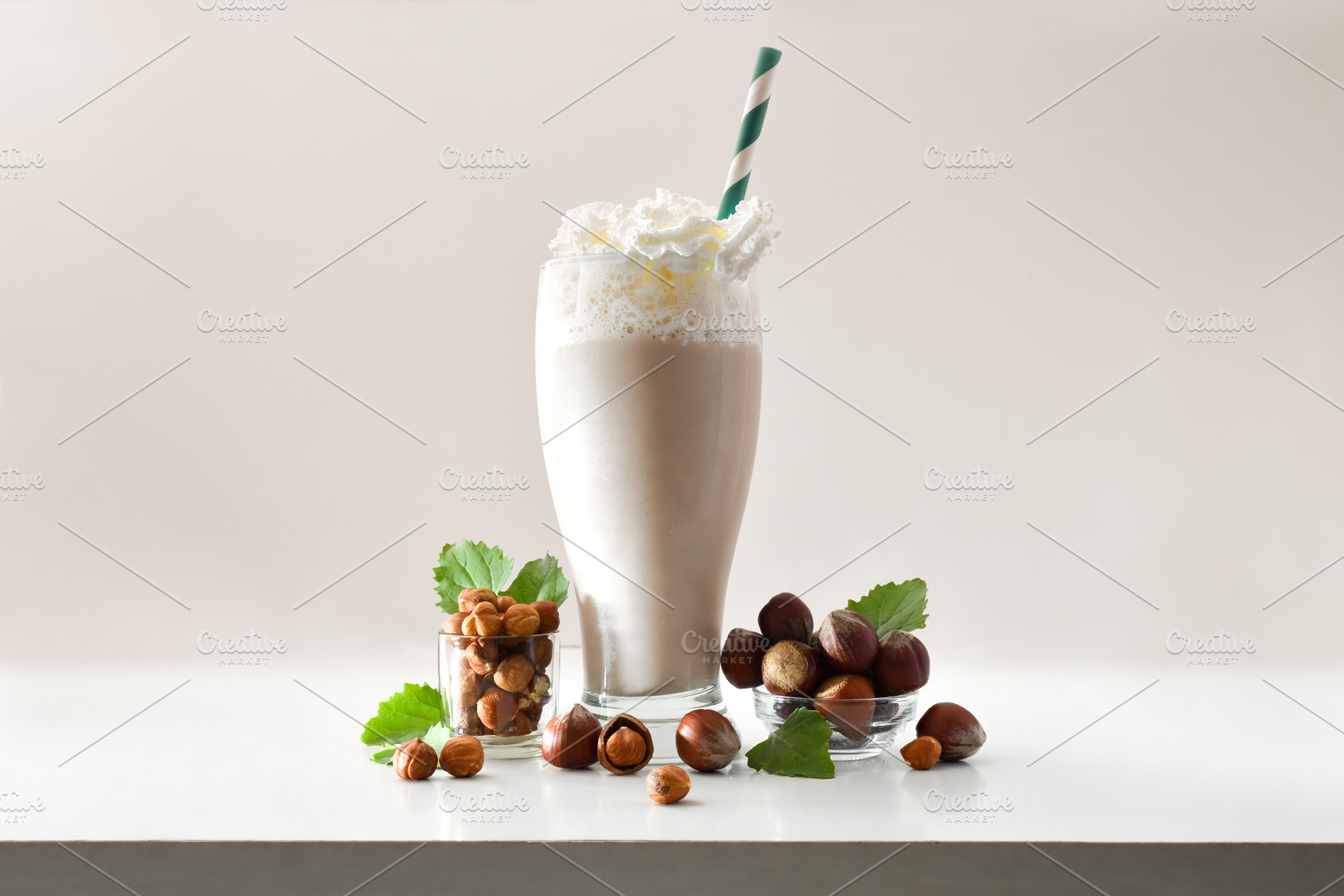 Glass with hazelnut smoothie with cream and bowls beige isolated, a Food & Drink Photo by Davizro's Market