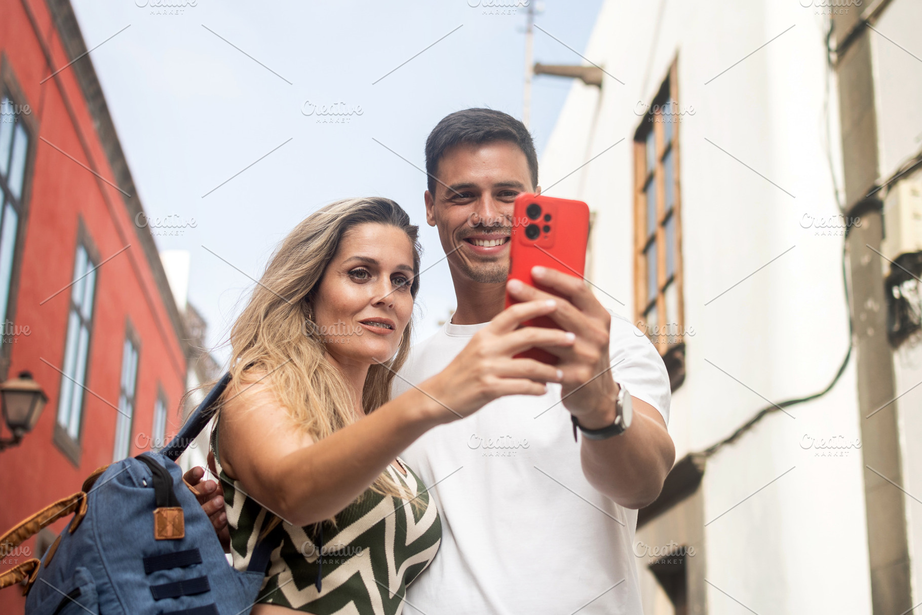 Tourist couple checking directions on smartphone, a Person Photo by etorres69