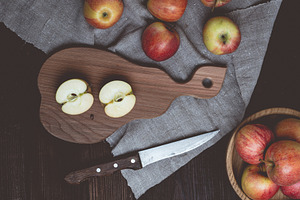 Ripe red apples on a wooden board, top view, a Food & Drink Photo by ndanko