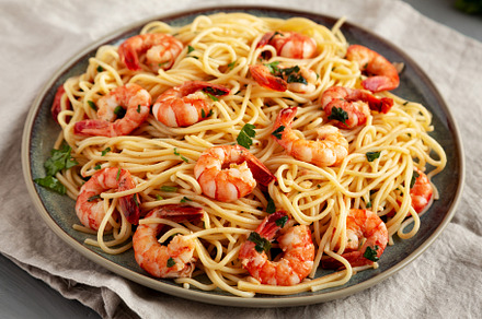 Homemade Cooked Garlic Shrimp Scampi on a Plate, side view., a Food & Drink Photo by LiudmylaChuhunova