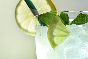 Refreshing drink with ice, mint and lemon with light background, a Food & Drink Photo by Davizro's Market