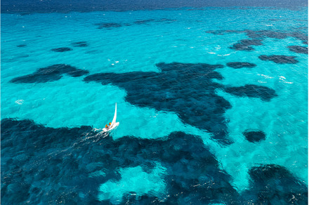 Aerial view of sailboat on blue sea, a Nature Photo by den-belitsky