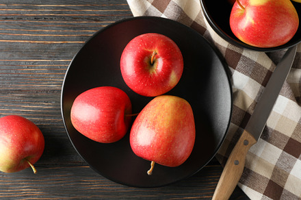 Composition with apples, plate and kitchen towel on wooden backg, a Food & Drink Photo by AtlasStudio