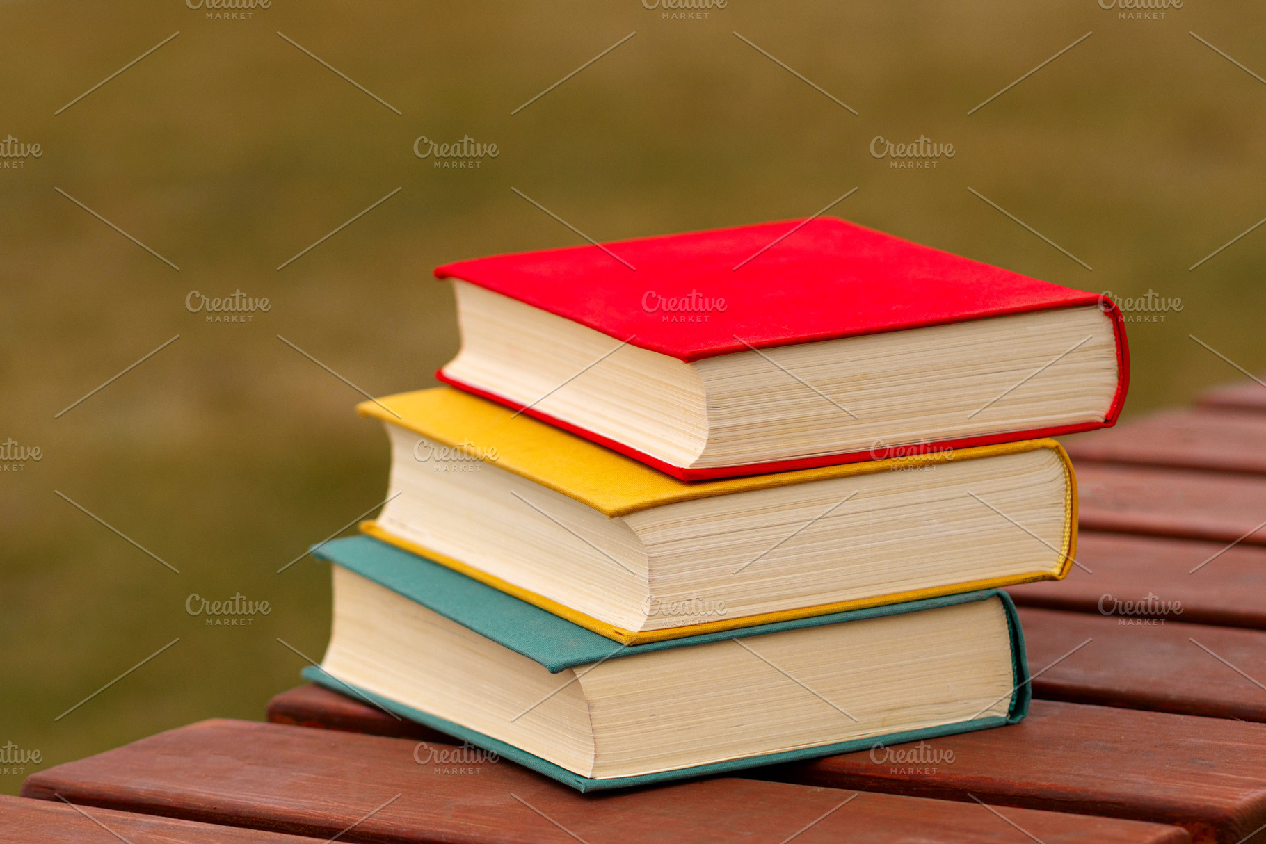 Stack of three colorful books, a School & Education Photo by Elena Vagengeim