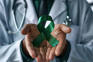 Doctor hands holding green ribbon, cancer awareness concept, a Photo by AlyaAnd