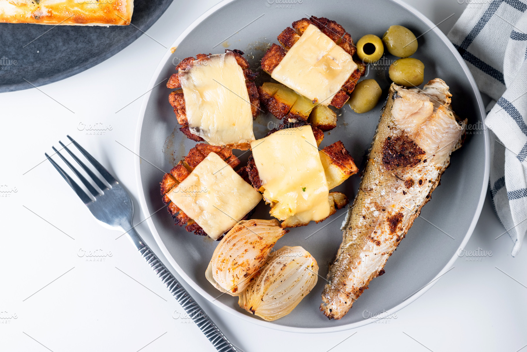 baked potatoes with cheese and fried fish on plate for lunch, a Food & Drink Photo by vimart