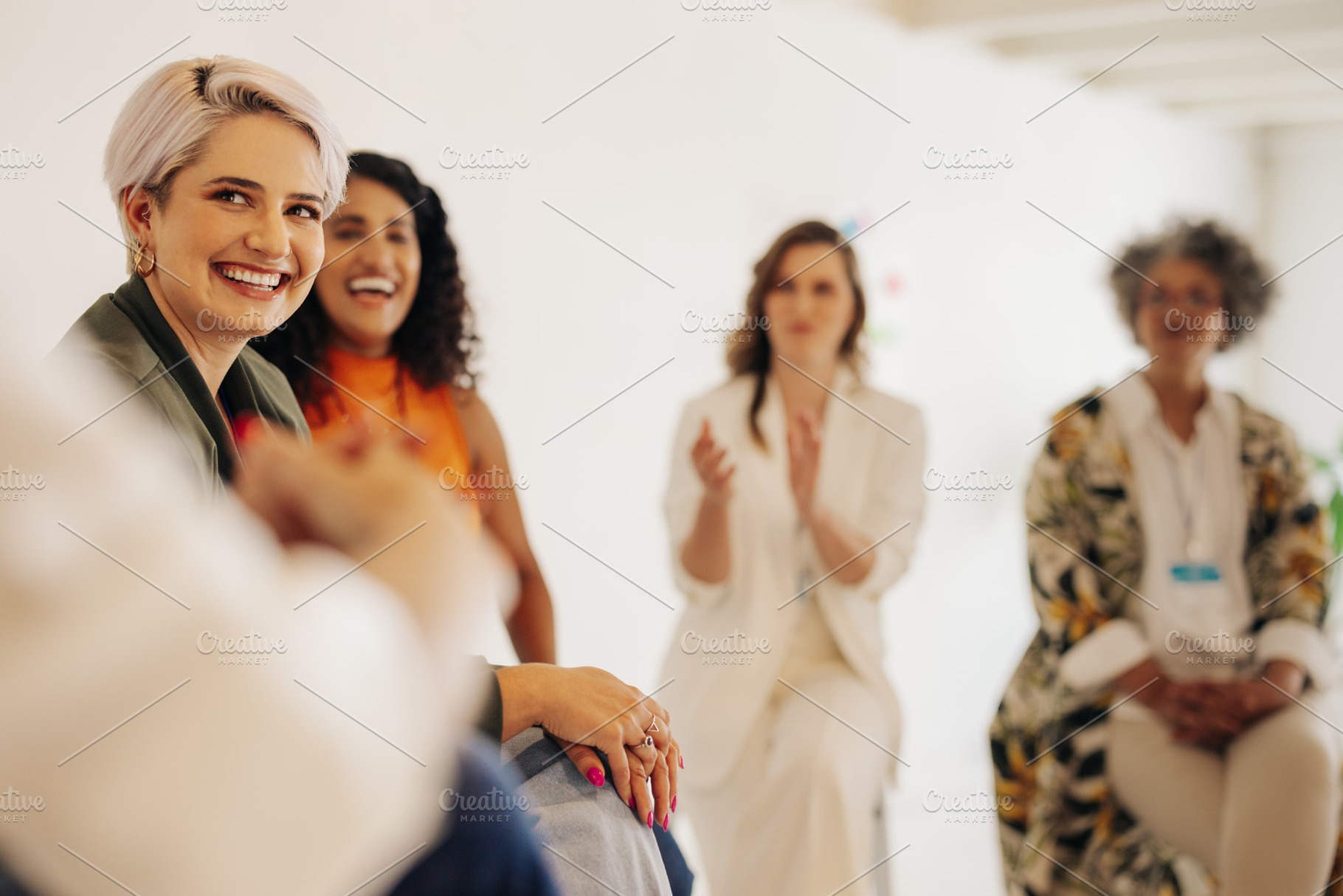 Businesswomen applauding their colleague during a meeting, a Person Photo by Jacob Lund