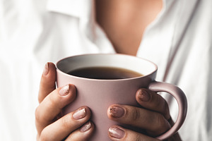 Woman holds morning coffee featuring woman, business, and design