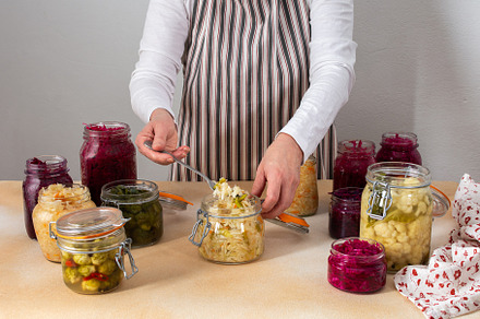 Woman fermenting fresh vegetables, a Food & Drink Photo by Pandateam