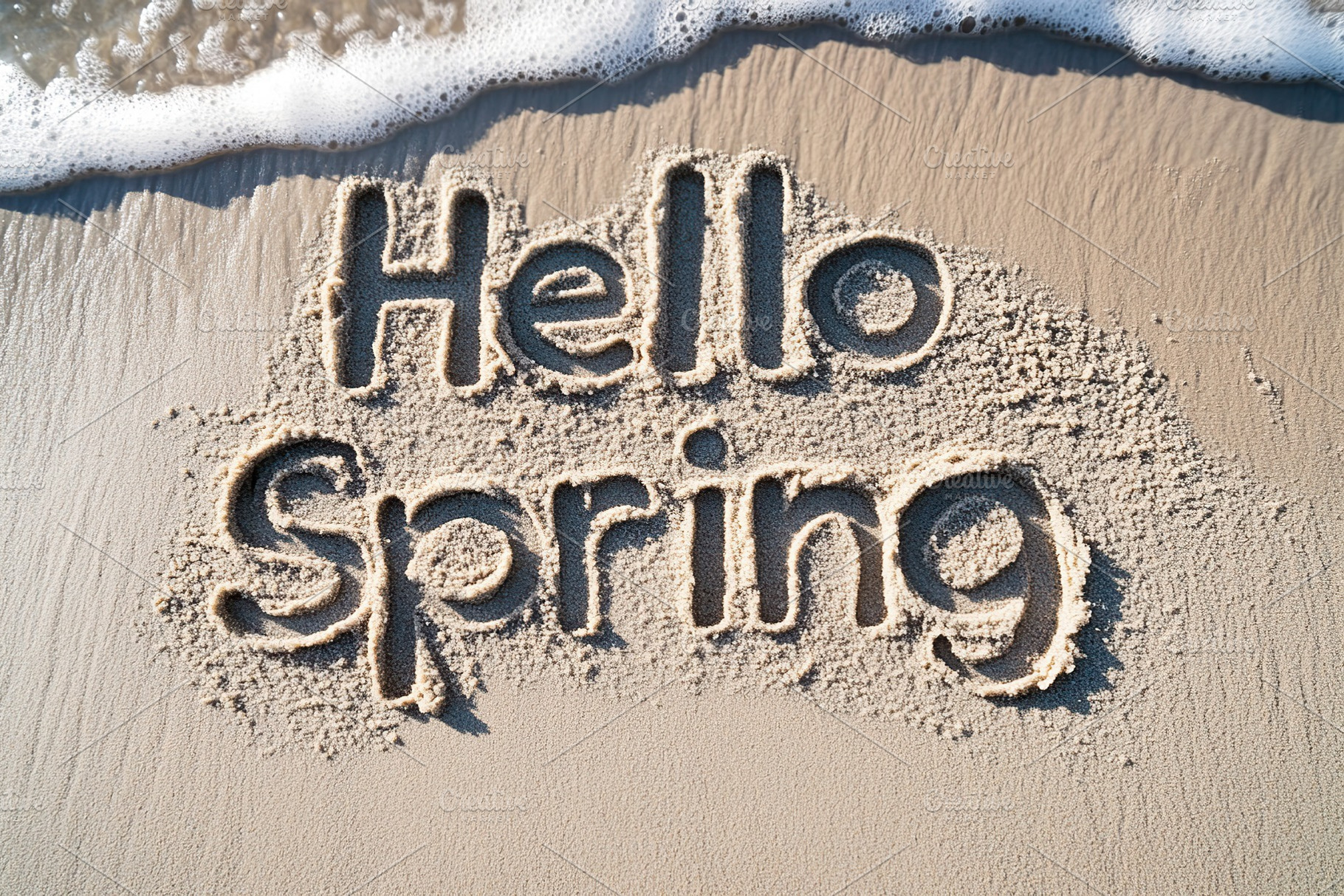 Inscription Hello Spring on beach sand, a Nature Photo by AlyaAnd
