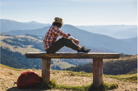 Male Hiker Resting on Top of the