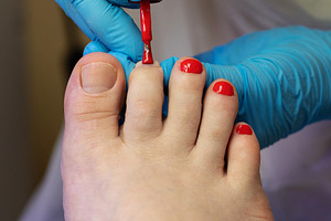 Close-up of toenail being painted, a Beauty & Fashion Photo by Elena Vagengeim
