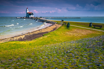 Cozy wooden lighthouse on the shore