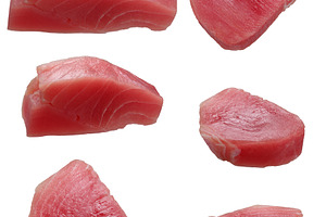 Various raw pieces of tuna on isolated background, a Food & Drink Photo by ndanko