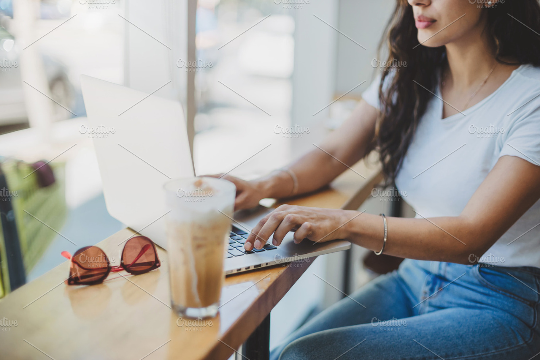 Business woman sitting in cafe containing laptop, woman, and using, a Business Photo by Anastasia Dudka