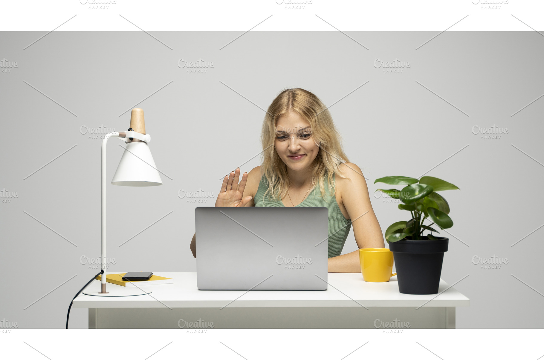 Young blonde woman greeting during, a Technology Photo by volodymyrshtun13795