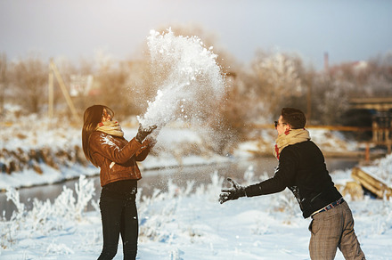 Young couple having fun in winter park featuring activity, adorable, and adult