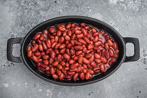 Kidney beans in a cast iron skillet on a rustic wooden board. La, a Food & Drink Photo by composter-box@mail.ru