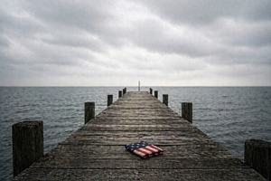 folded american flag on a long pier, generative AI, a Photo by Nito