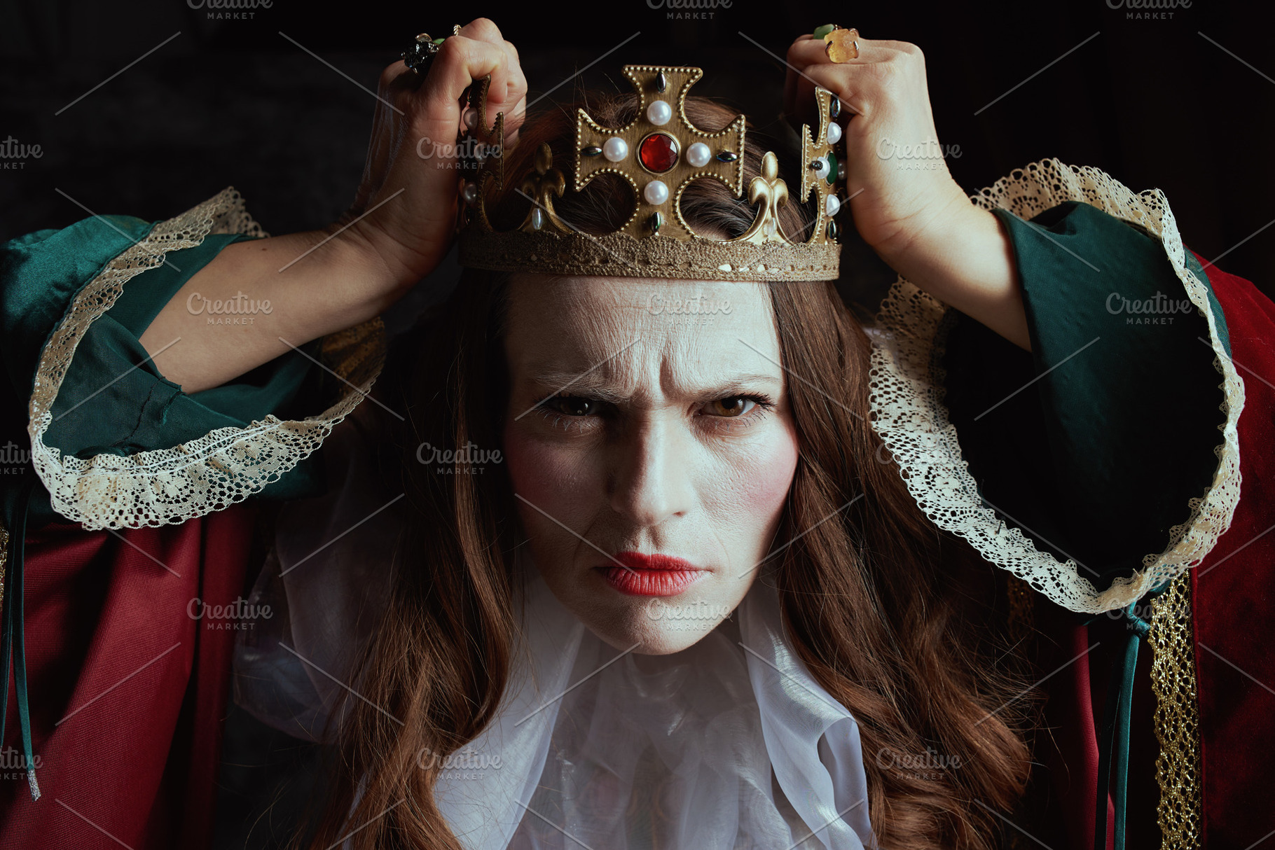 scary medieval queen in red dress with white collar and crown, a Person Photo by Alliance Images