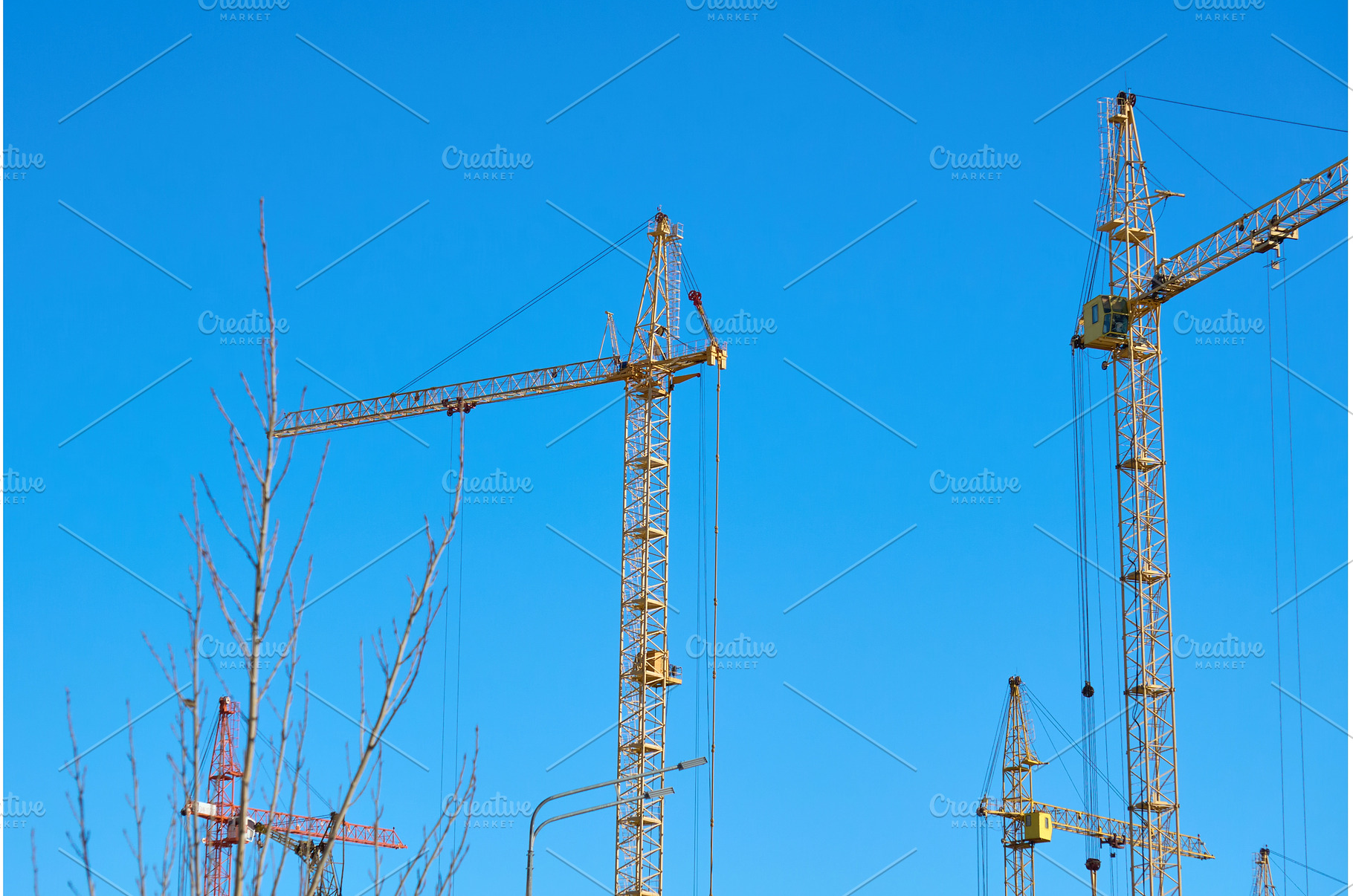 Cranes are lifting materials at a, an Industrial Photo by darksoul72