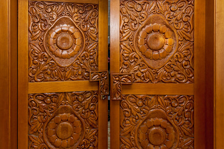 Wooden door with carved patterns, an Arts & Entertainment Photo by Photostock