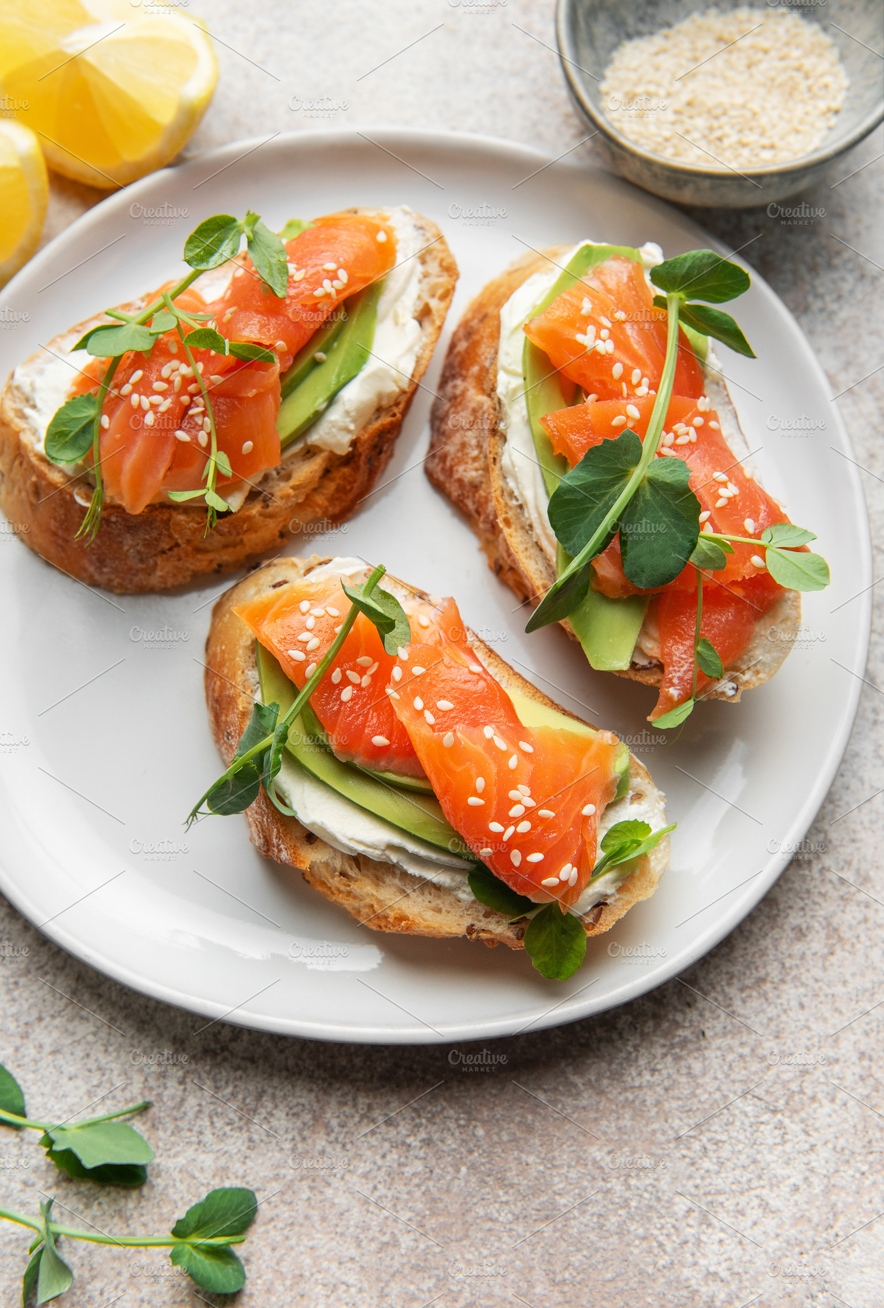 Salmon avocado bruschetta with cream cheese and lemon, a Food & Drink Photo by Olena Rudo