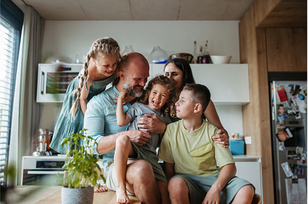 Cheerful family with three kids, a Person Photo by HalfPoint