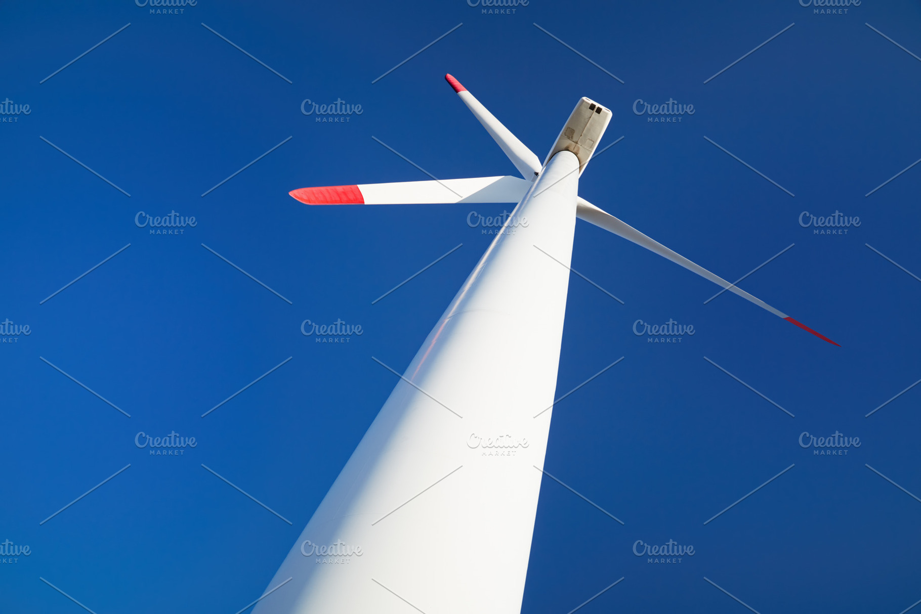 Wind turbine over blue sky, an Industrial Photo by Shop Name