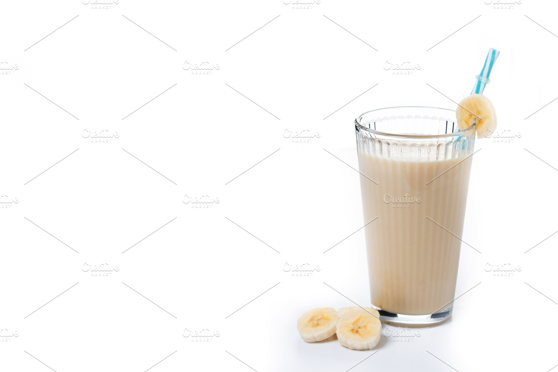 Fresh and healthy banana smoothie in glass isolated on white background., a Food & Drink Photo by etorres69