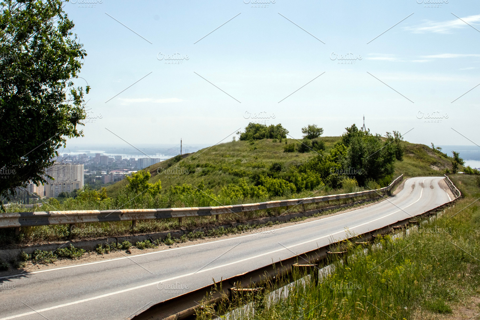 The asphalt road goes around hill, a Transportation Photo by Schreibikus