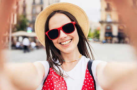 Happy young woman making selfie with smart phone in the city street - Joyful fe, a Holiday Photo by Xavier Lorenzo