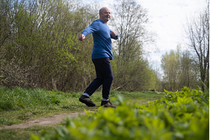 Active senior man is jogging in park