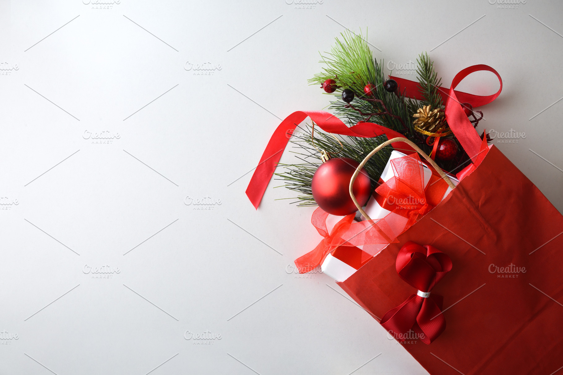 Red shopping bag full of gifts isolated on white table, a Holiday Photo by Davizro's Market