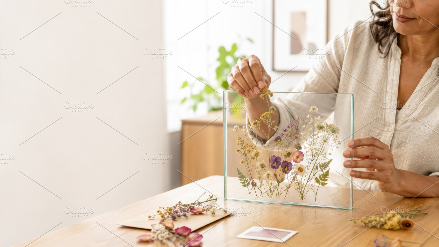 Woman arranging dried pressed flower, a Photo by Dvoevnore photos