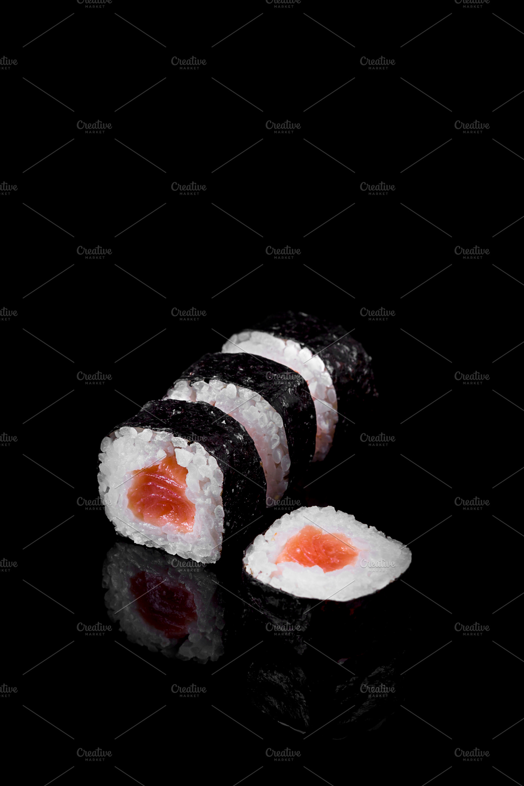 Makis tuna sushi on black ground, a Food & Drink Photo by Zama Studio