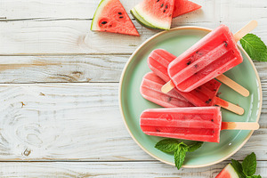 Ice cream popsicles with watermelon in plate on wooden background, a Food & Drink Photo by AlyaAnd