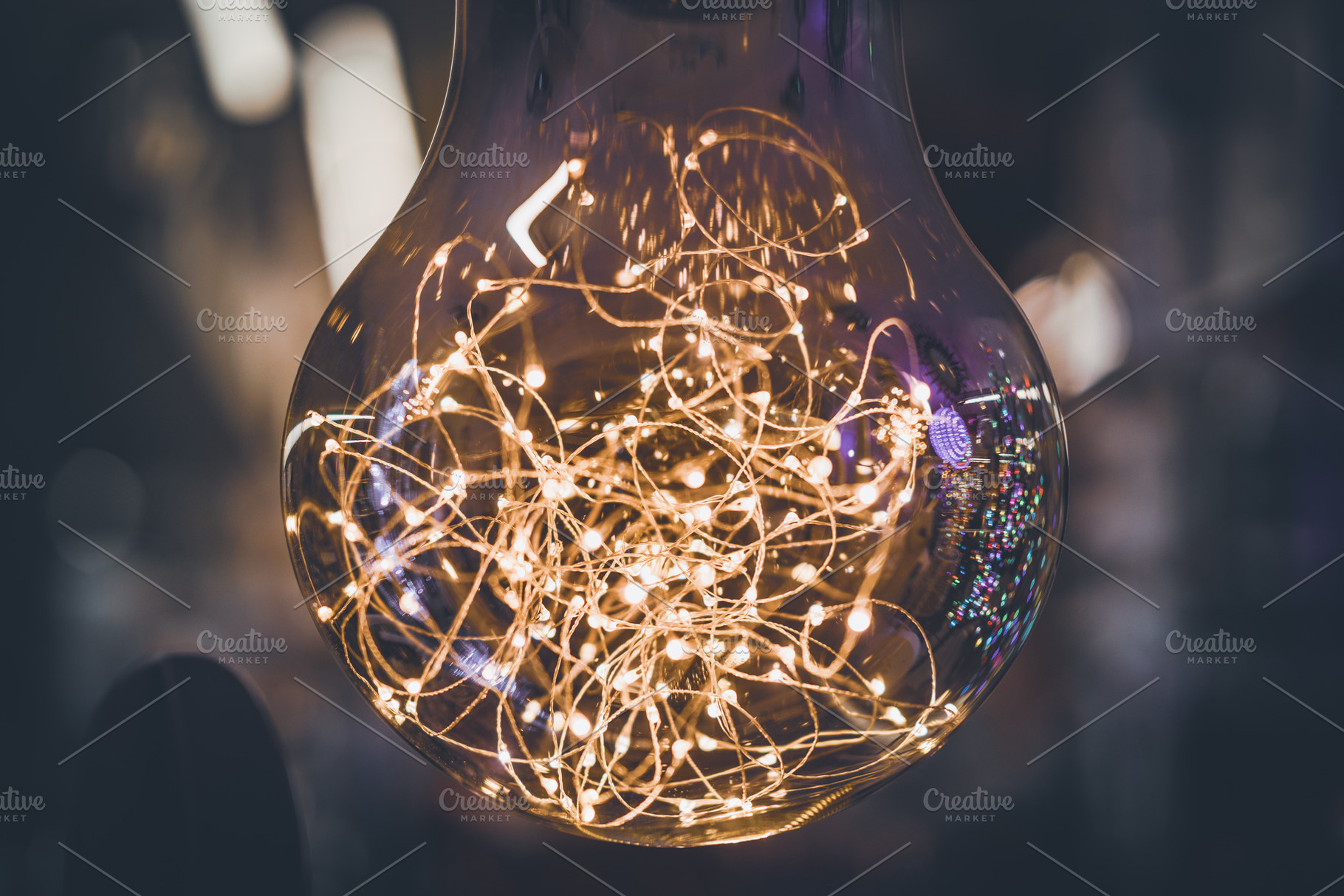 Giant light bulb with light garlands, an Abstract Photo by Visual Motiv