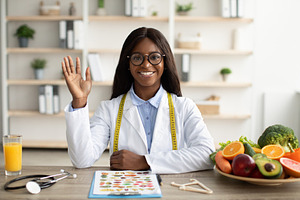 Portrait of happy african american nutritionist giving online consultations to, a Person Photo by Prostock-Studio